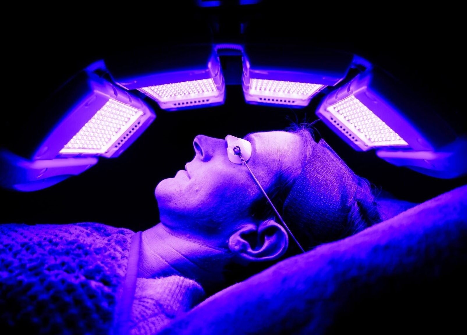 Person receiving LED light therapy at Socair Centre, Oban, Scotland, GB for rejuvenating skin treatment.