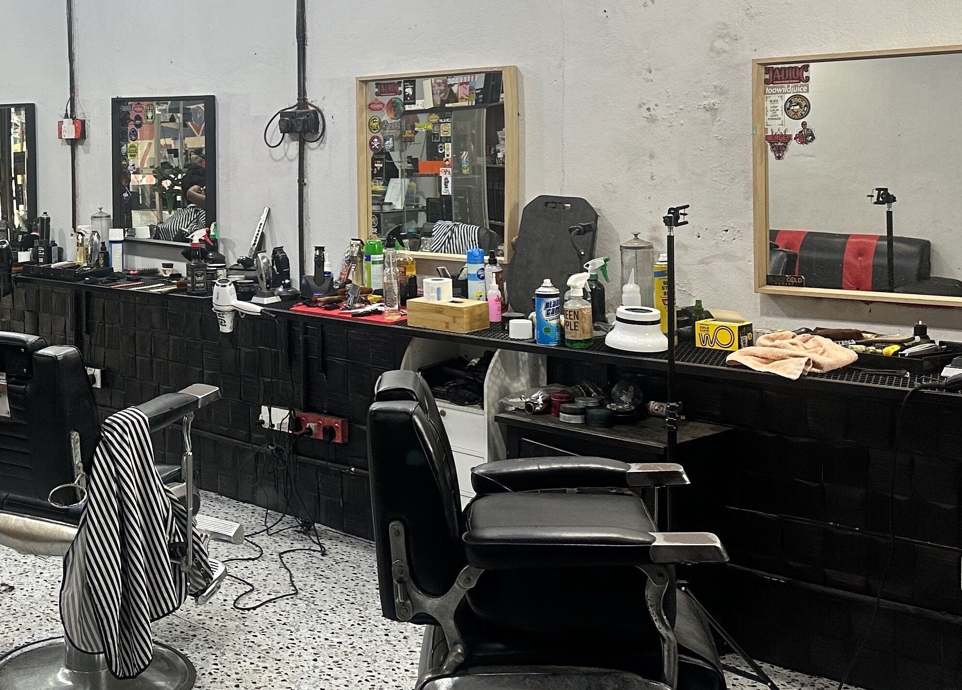 Elegant barber chair setup at MTB Barbershop and Academy in Langkawi, Kedah, MY showcasing tools and mirrors.