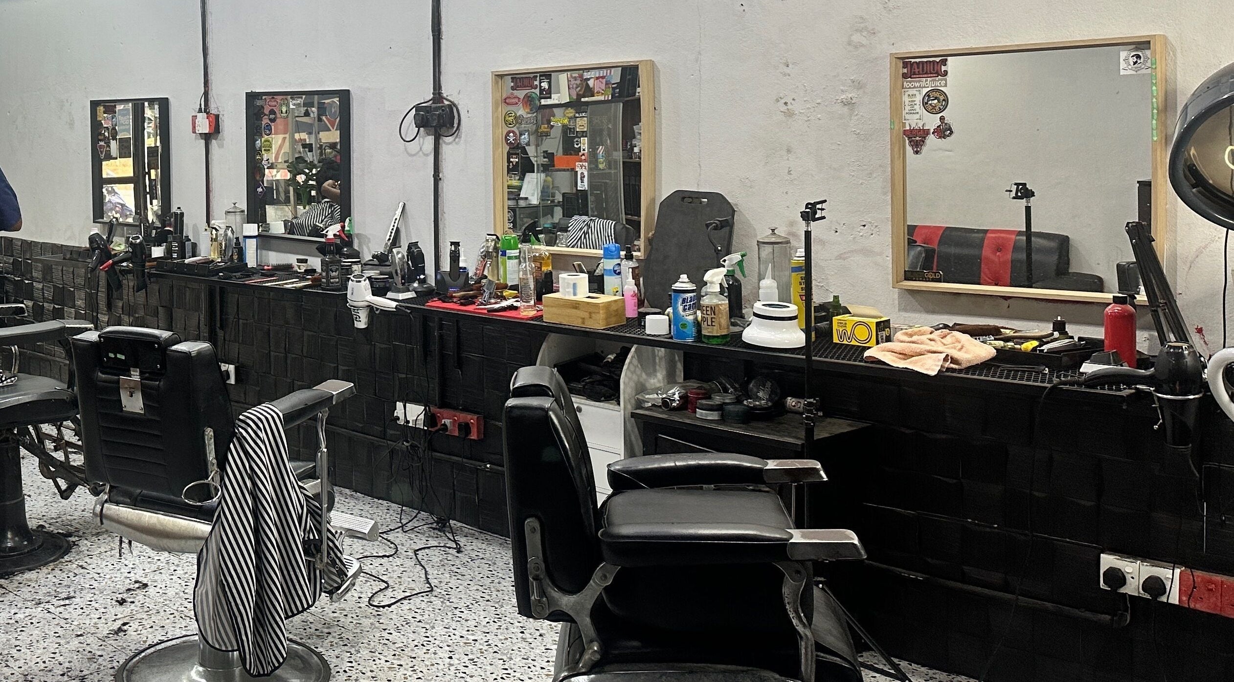 Elegant barber chair setup at MTB Barbershop and Academy in Langkawi, Kedah, MY showcasing tools and mirrors.