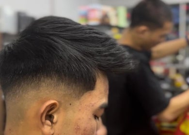Man receiving a stylish fade haircut at MTB Barbershop and Academy, Langkawi, Kedah, MY.