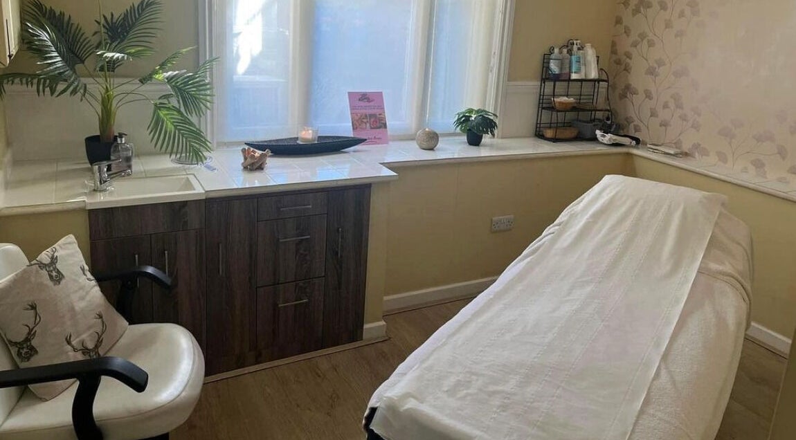 Relaxing treatment room at The Beauty Zone, Crewkerne, England, GB, with a massage bed and calming decor.