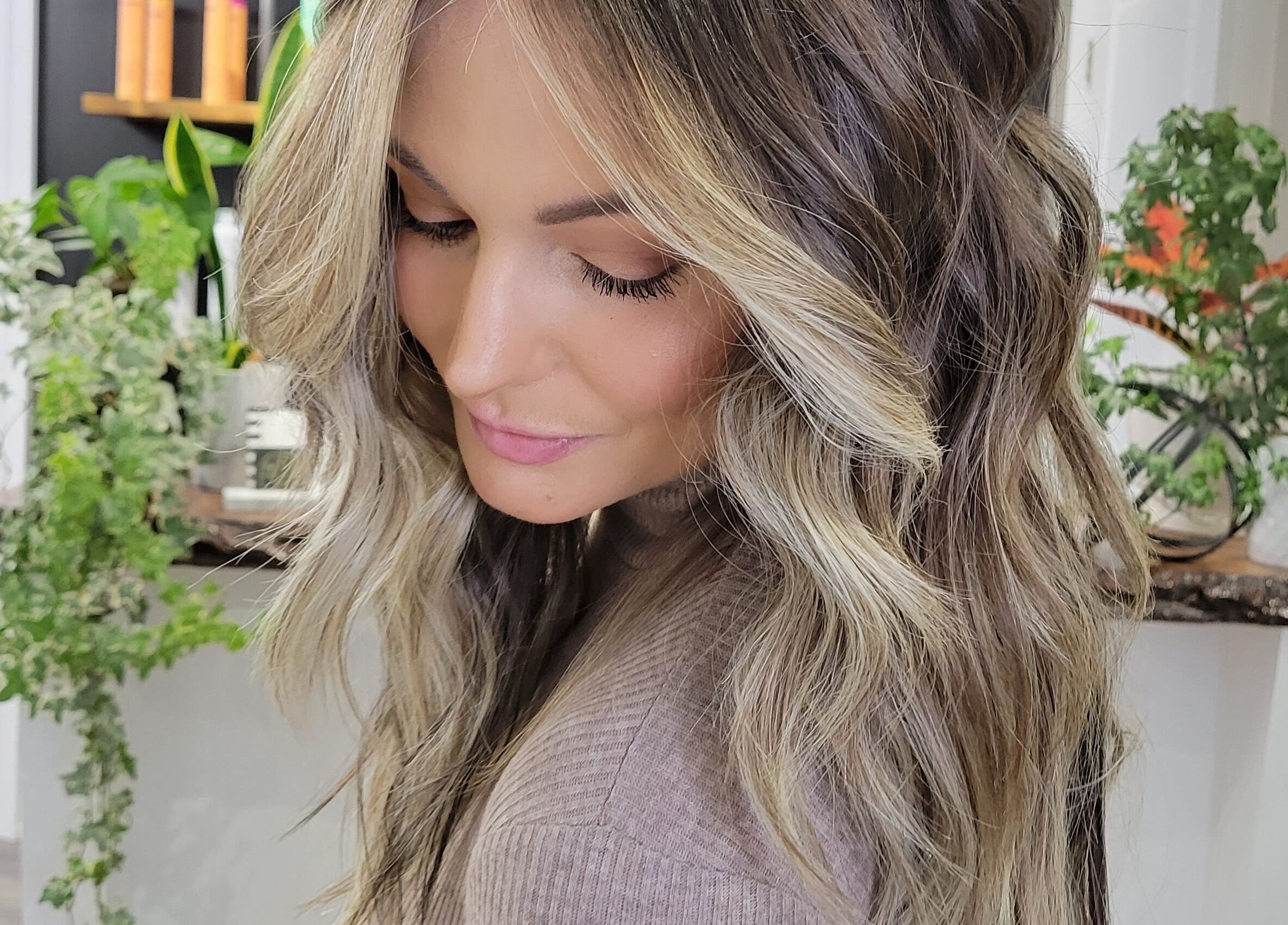 Elegant wavy hairstyle at Hair Studio Midland, located in Midland, Ontario, CA, showcasing vibrant hair color.