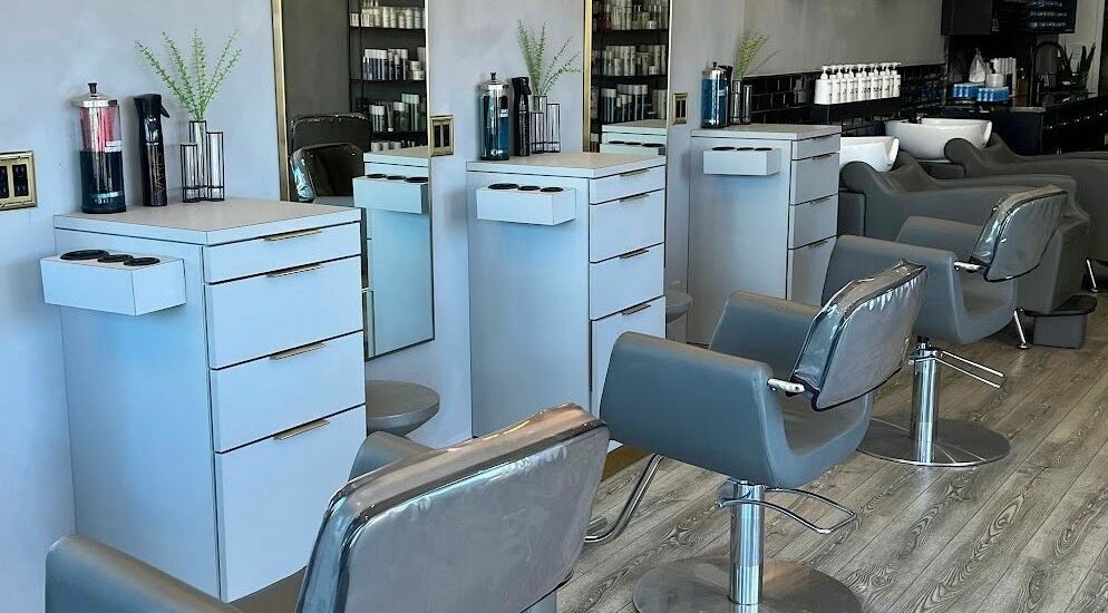 Modern interior of Glass Beauty Bar in Rockville Centre, New York, US, featuring stylish salon chairs and mirrors.