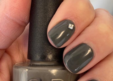 Charcoal gray manicured nails with gem detail at Polished in Valparaiso, Indiana, US.