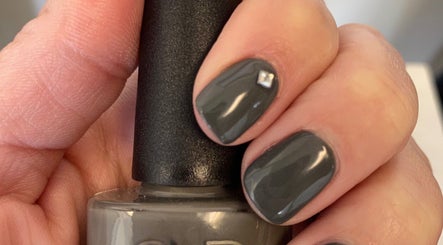 Charcoal gray manicured nails with gem detail at Polished in Valparaiso, Indiana, US.