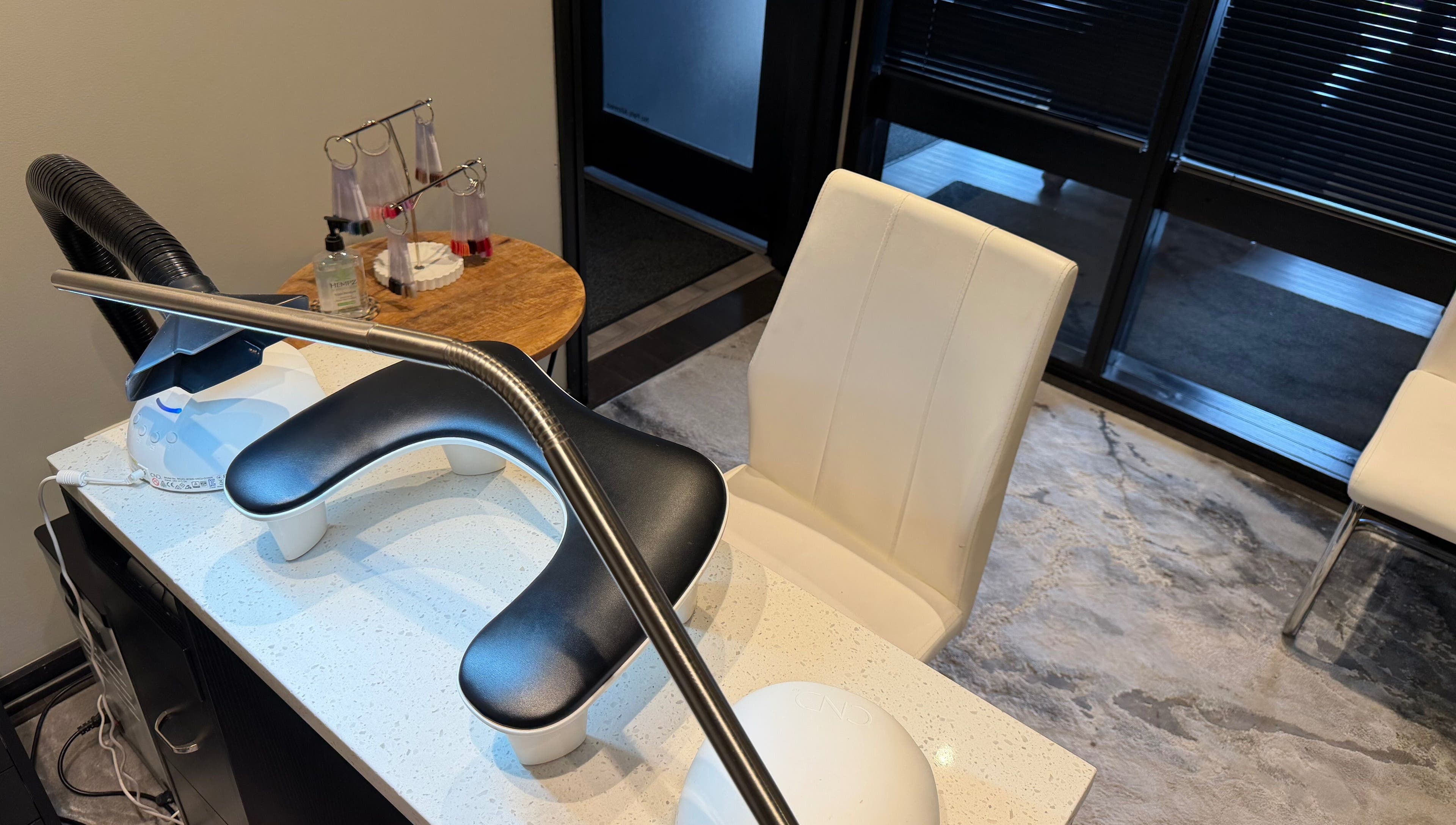Nail salon station at Polished, Valparaiso, Indiana, US, featuring modern chairs and manicure tools.