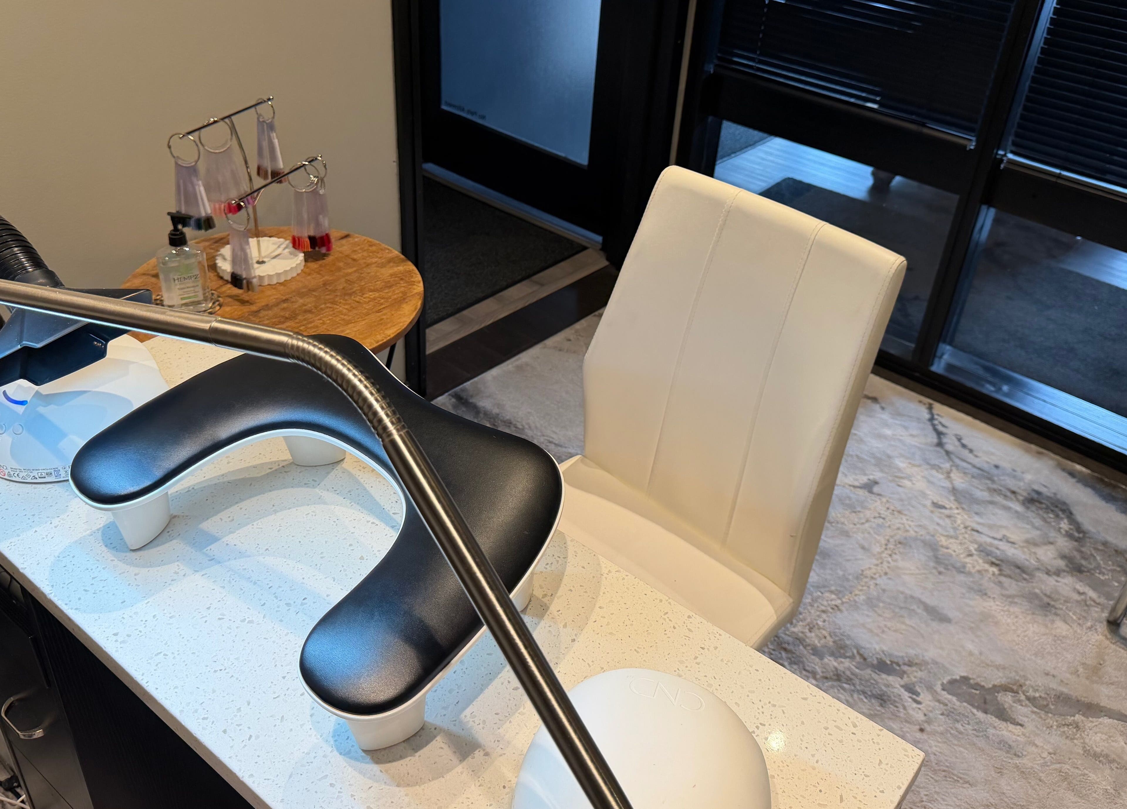 Nail salon station at Polished, Valparaiso, Indiana, US, featuring modern chairs and manicure tools.