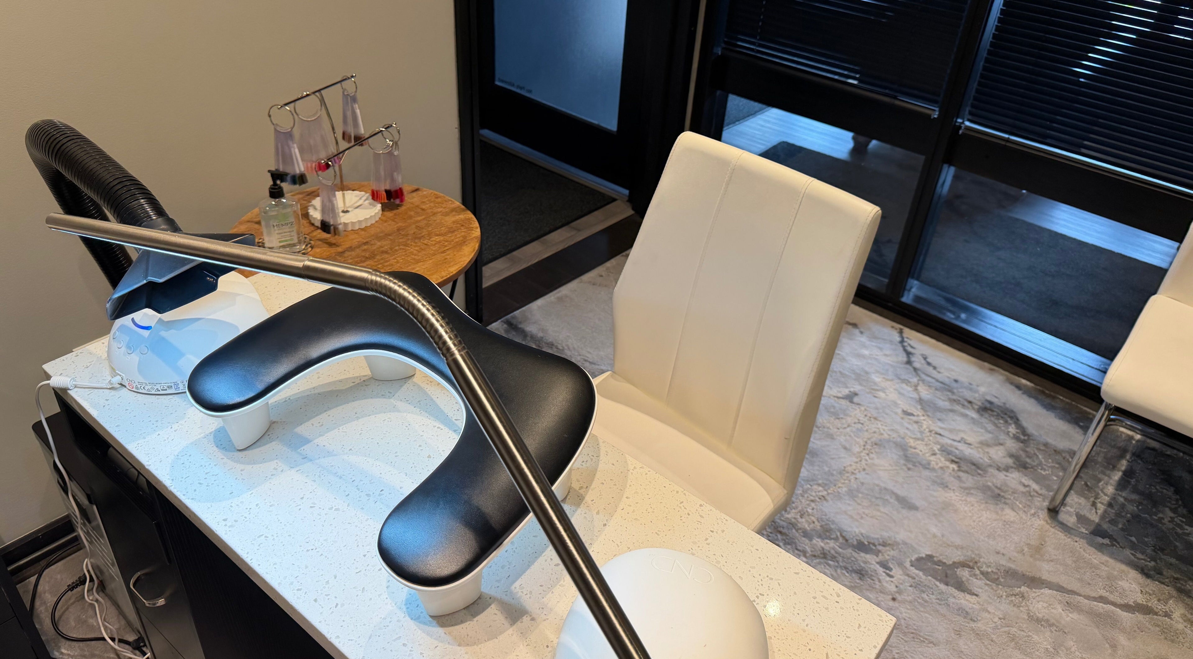 Nail salon station at Polished, Valparaiso, Indiana, US, featuring modern chairs and manicure tools.