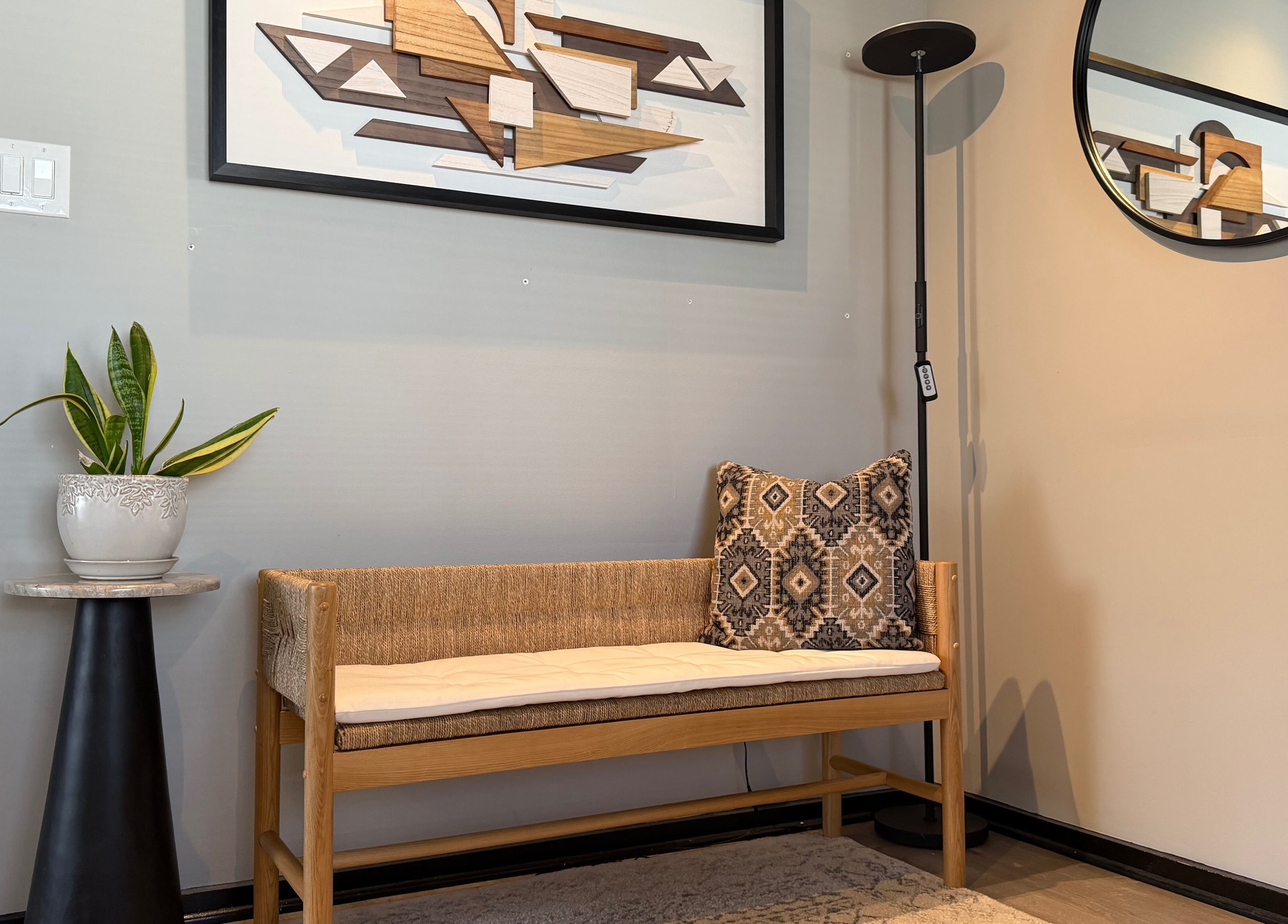 Stylish waiting area at Polished in Valparaiso, Indiana, US with art, cozy bench, and plant decor.