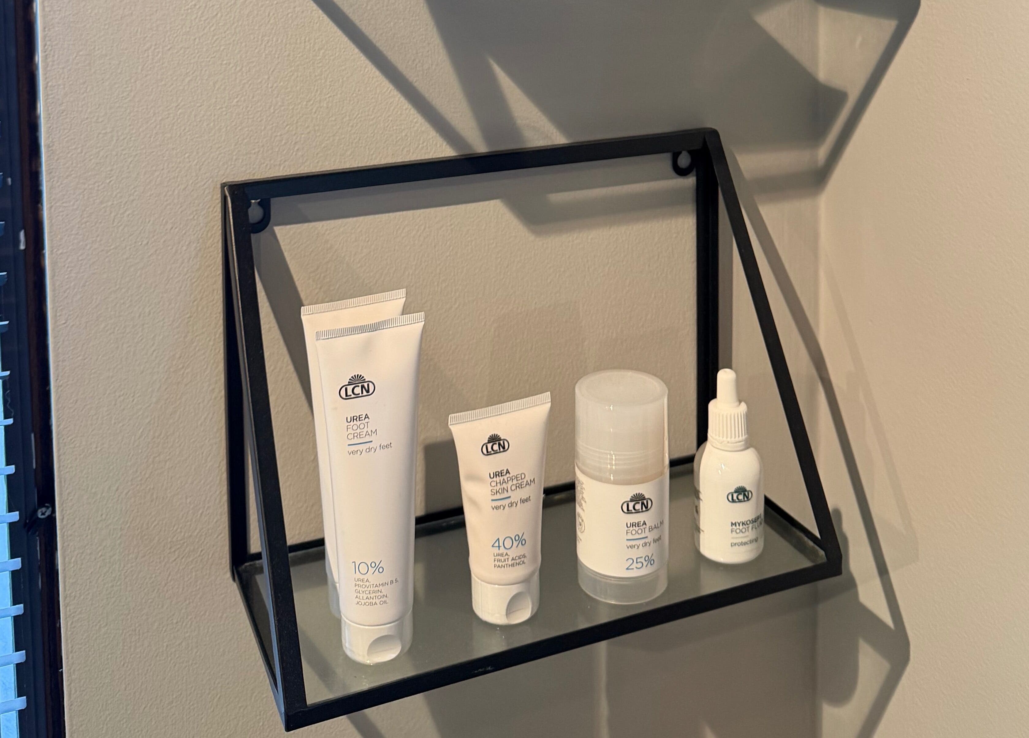 Polished in Valparaiso, Indiana, US displays elegant skincare products on a stylish wall shelf.