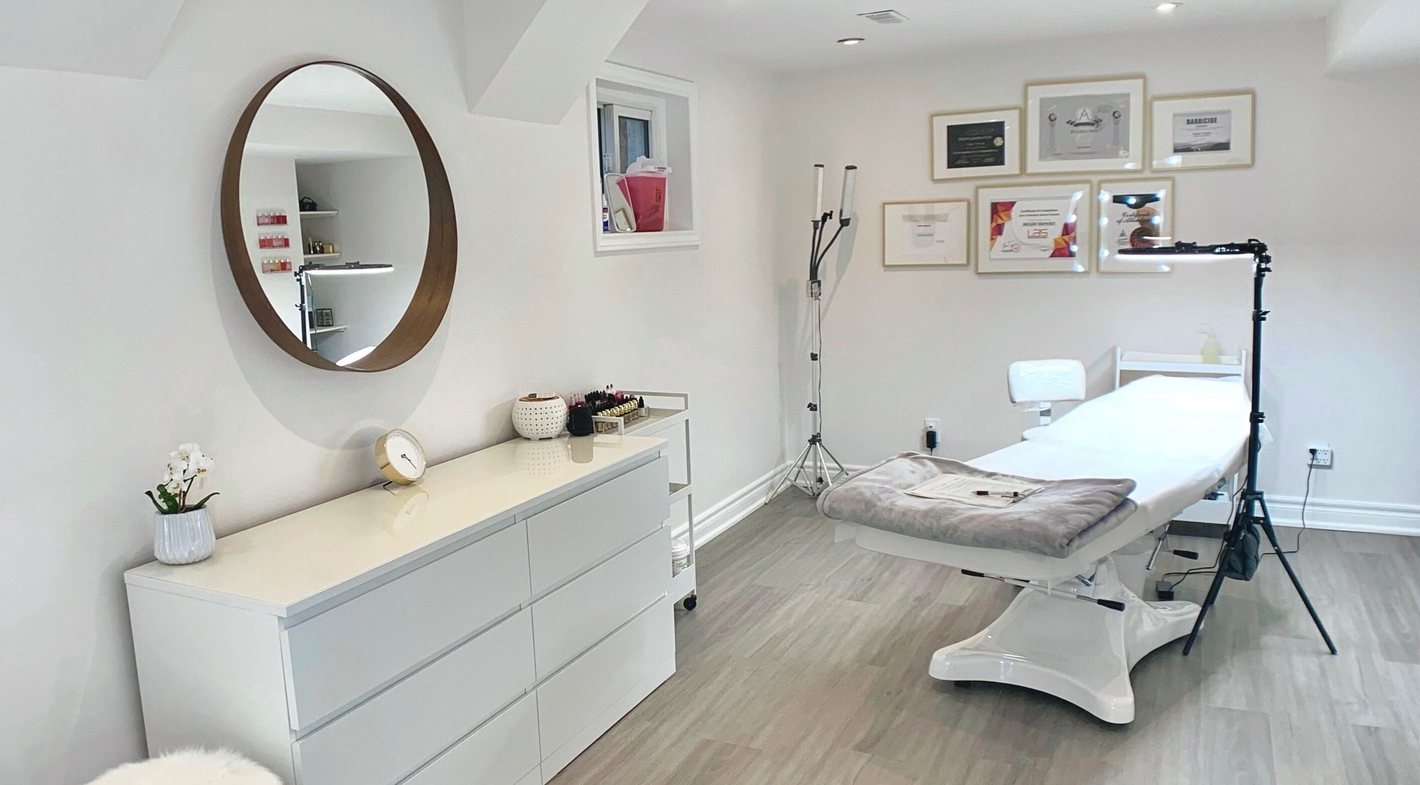 Modern treatment room at Arc Beauty Studio, Toronto, Ontario, CA with white decor and cozy lighting.