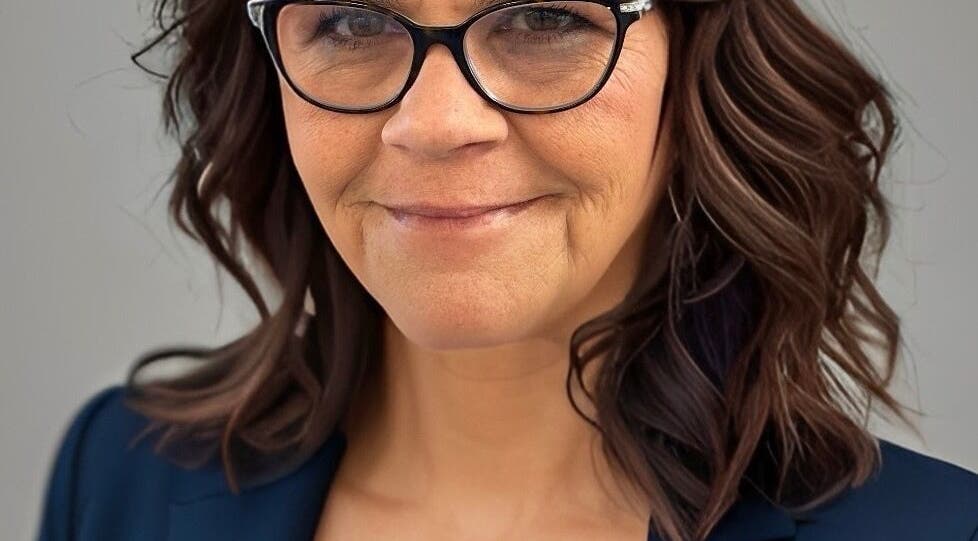 Stylish woman with glasses at Alluring Locks, Mount Carmel, Illinois, US, showcasing luxury hair style.