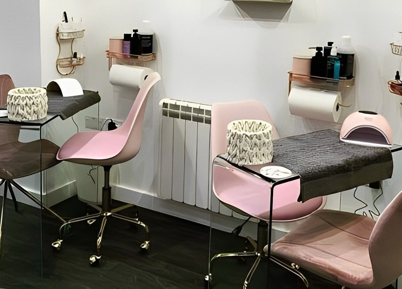 Modern manicure station at Elite Beauty and Spa in Kent, England, GB, showcasing elegant pink chairs and tools.