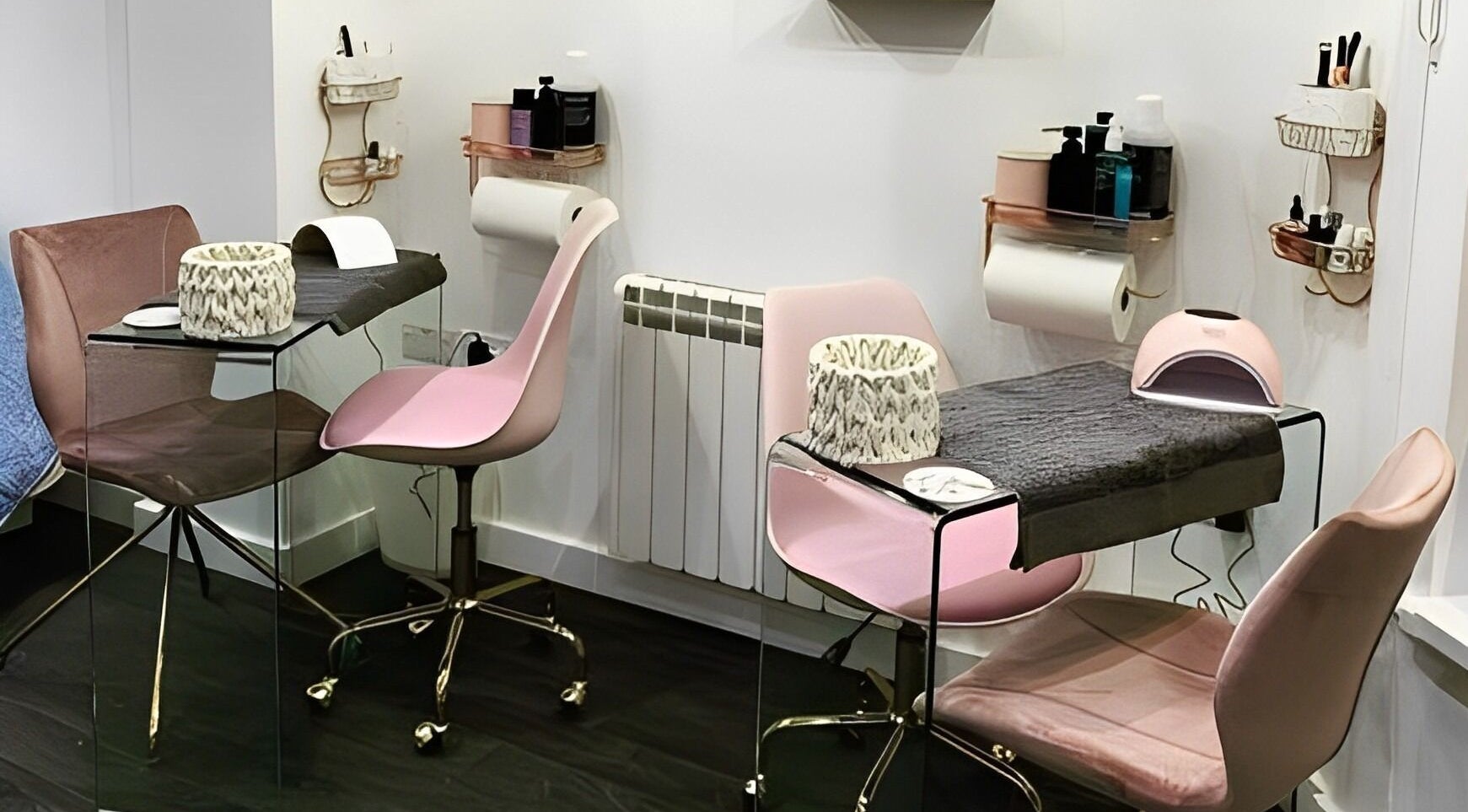 Modern manicure station at Elite Beauty and Spa in Kent, England, GB, showcasing elegant pink chairs and tools.