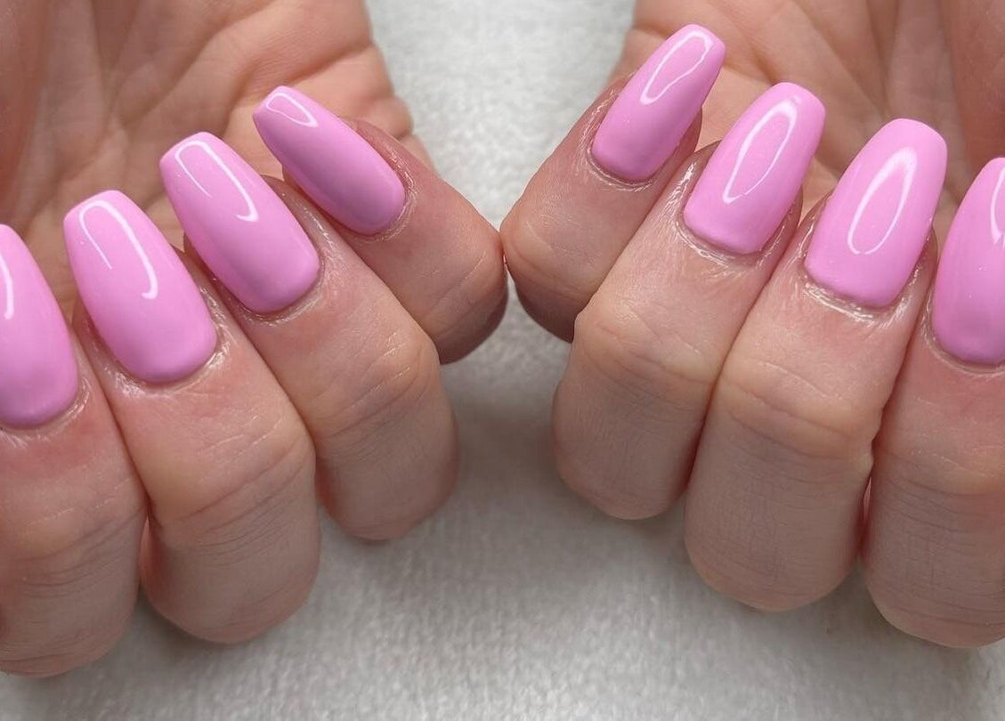 Vibrant pink nails at Elite Beauty and Spa in Kent, England, GB showcasing salon-quality manicure.