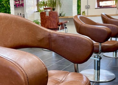 Elegant leather chairs at Seacombe & Co., Chichester, England, GB, offering premium salon experience.