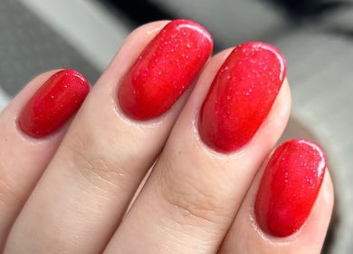 Vibrant red manicure at Laura Bremner Nails and Beauty in Cardenden, Scotland, GB.