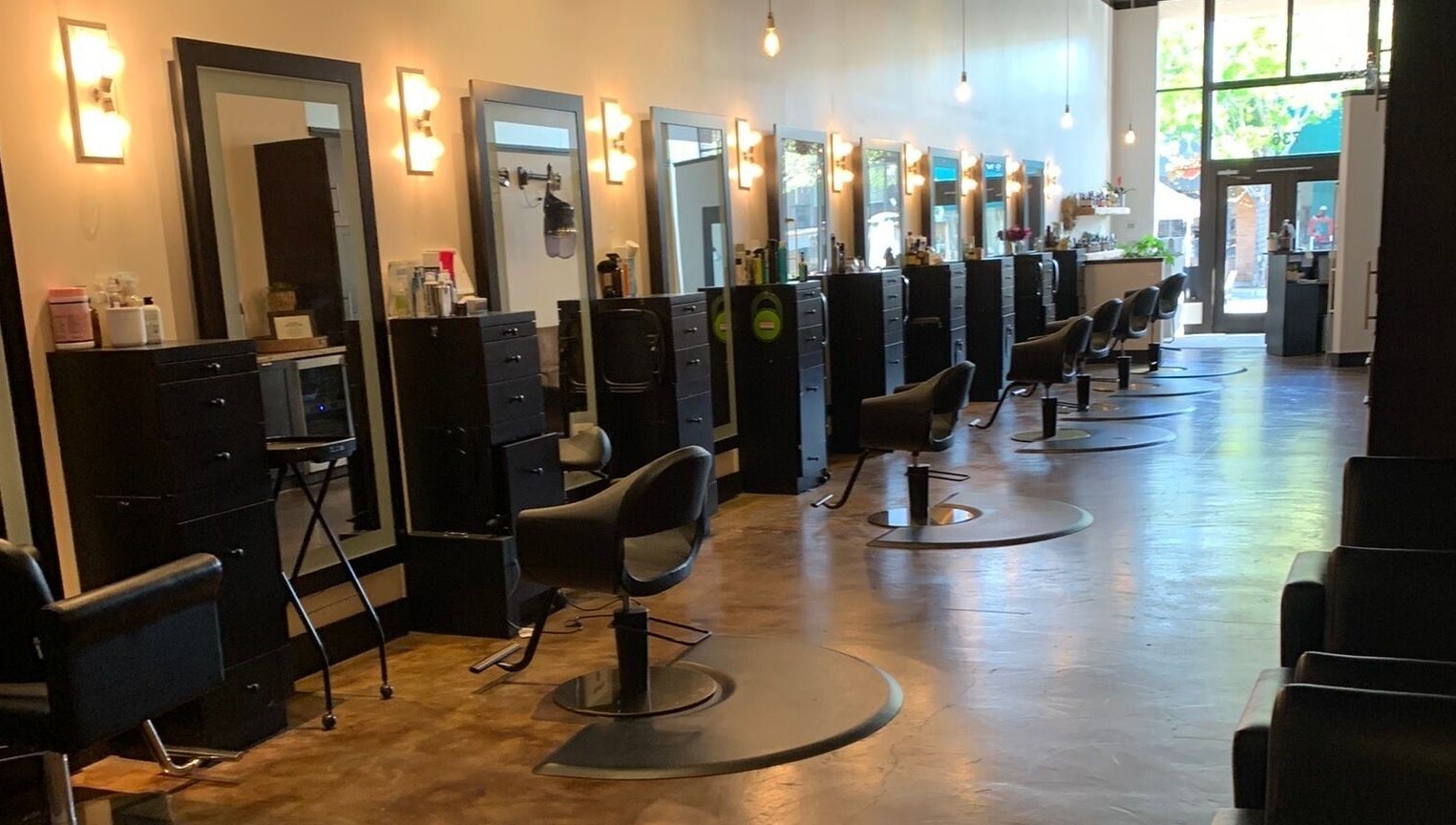 Sleek interior of Adriana at Salon Vivo, showcasing styling chairs and mirrors in San Carlos, California, US.