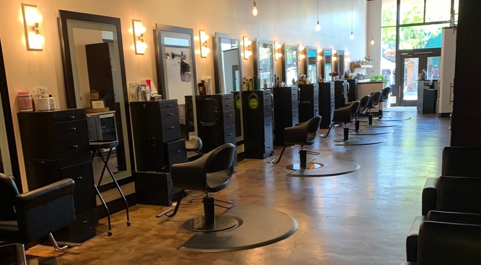 Sleek interior of Adriana at Salon Vivo, showcasing styling chairs and mirrors in San Carlos, California, US.
