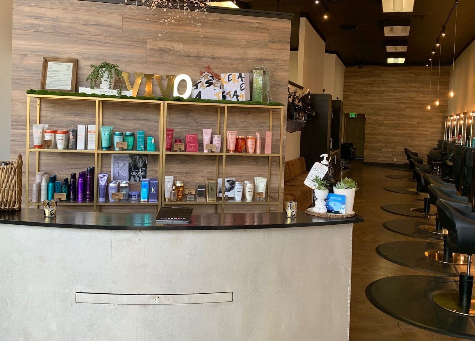 Elegant reception area at Adriana at Salon Vivo in San Carlos, California, US, showcasing hair care products.
