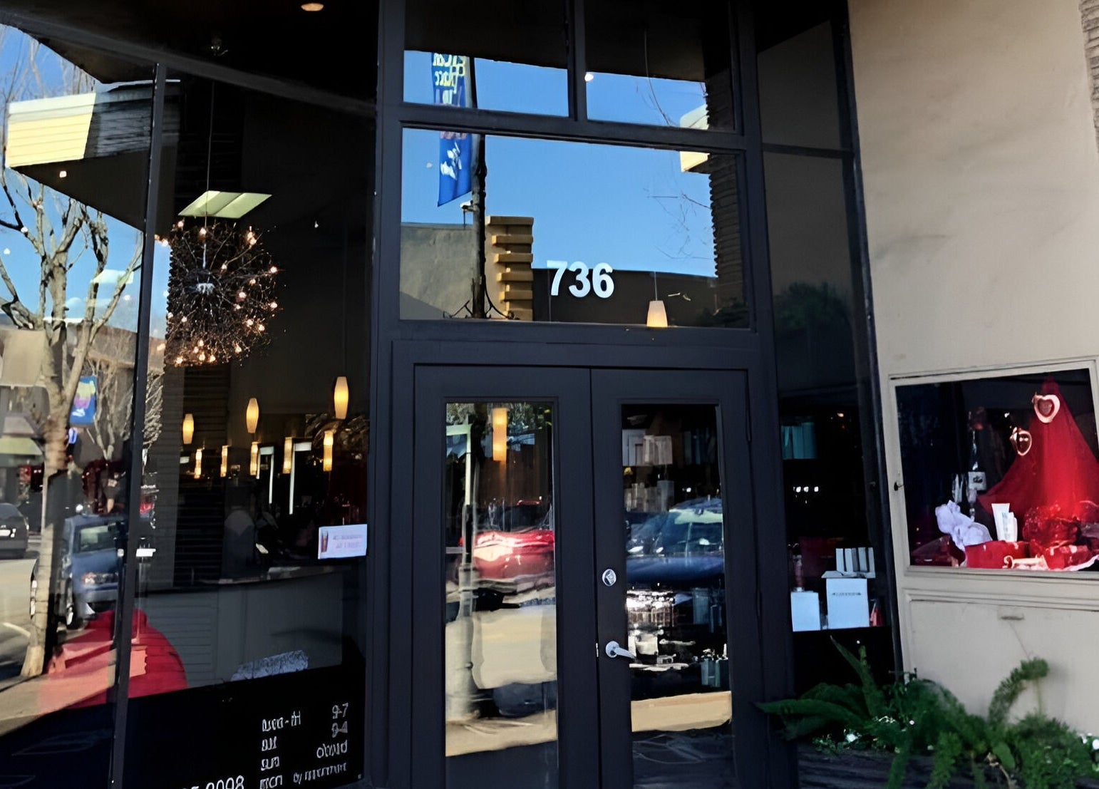 Entrance of Adriana at Salon Vivo in San Carlos, California, US, showcasing modern glass doors and stylish decor.