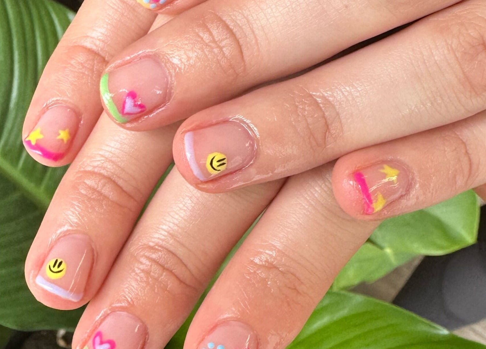 Colorful nail art with smiley and stars at Red Desert Beauty, Uleybury, South Australia, AU.