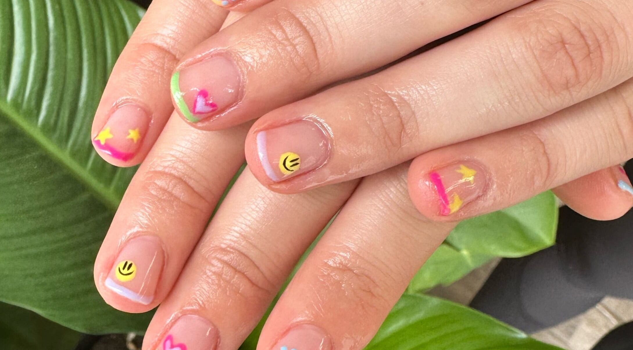 Colorful nail art with smiley and stars at Red Desert Beauty, Uleybury, South Australia, AU.