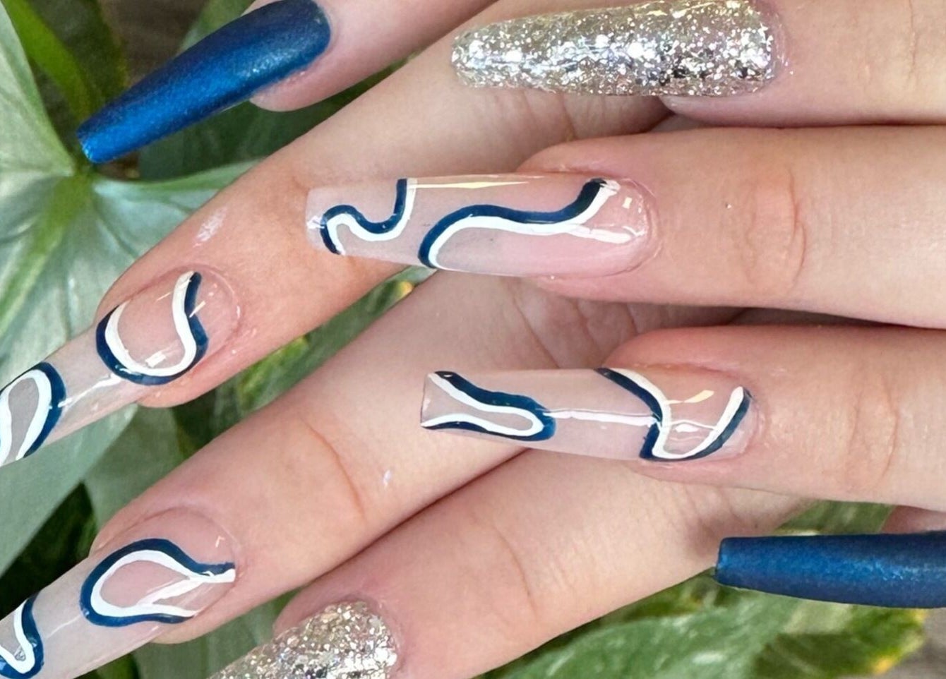 Creative nail art with blue designs at Red Desert Beauty, Uleybury, South Australia, AU.