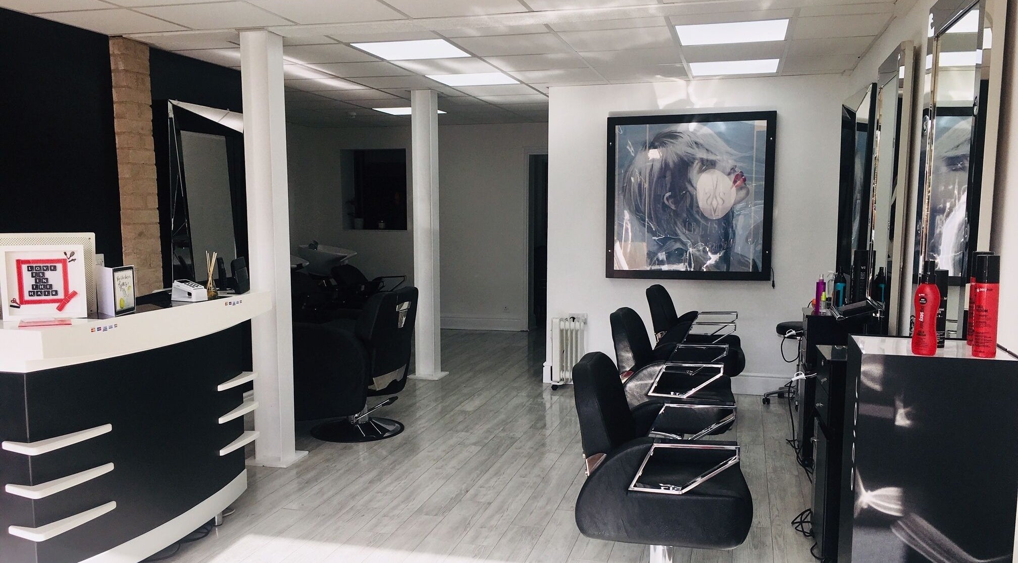 Interior of Melissa's Hair Salon, Blackpool, England, GB, showcasing stylish black seating and modern decor.