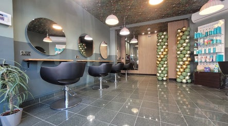 Modern salon interior at Gareth @ Artistic Hair Co, Bristol, England, GB, showcasing stylish chairs and mirrors.