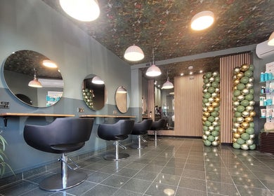 Modern interior of Gareth at Artistic Hair Co in Bristol, England, GB, featuring stylish chairs and elegant décor.