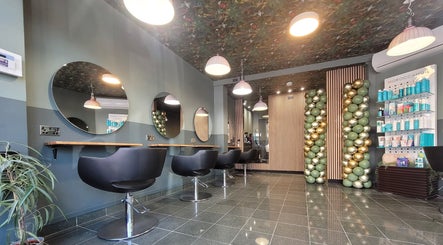 Modern interior of Gareth at Artistic Hair Co in Bristol, England, GB, featuring stylish chairs and elegant décor.