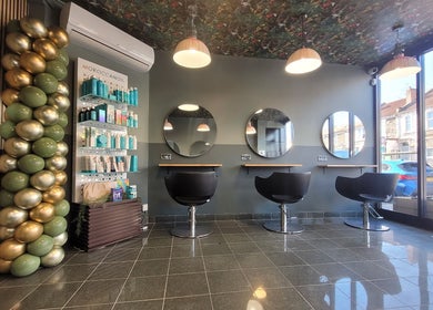 Sleek and modern salon interior at Gareth at Artistic Hair Co, Bristol, England, GB with chairs and mirrors.