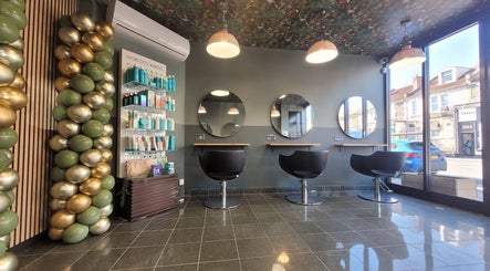 Sleek and modern salon interior at Gareth at Artistic Hair Co, Bristol, England, GB with chairs and mirrors.