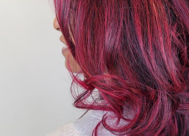 Vibrant red curls styled at Gareth at MITI BEAUTY in Bristol, England, GB, showcasing hair artistry.