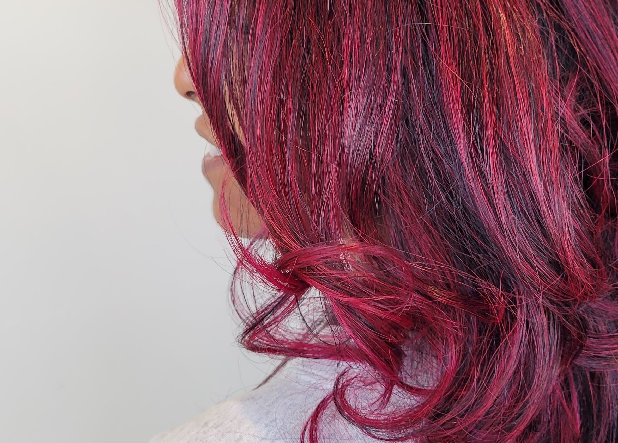Vibrant crimson curls styled at Gareth at The Loft Hair Studio, Bristol, England, GB.