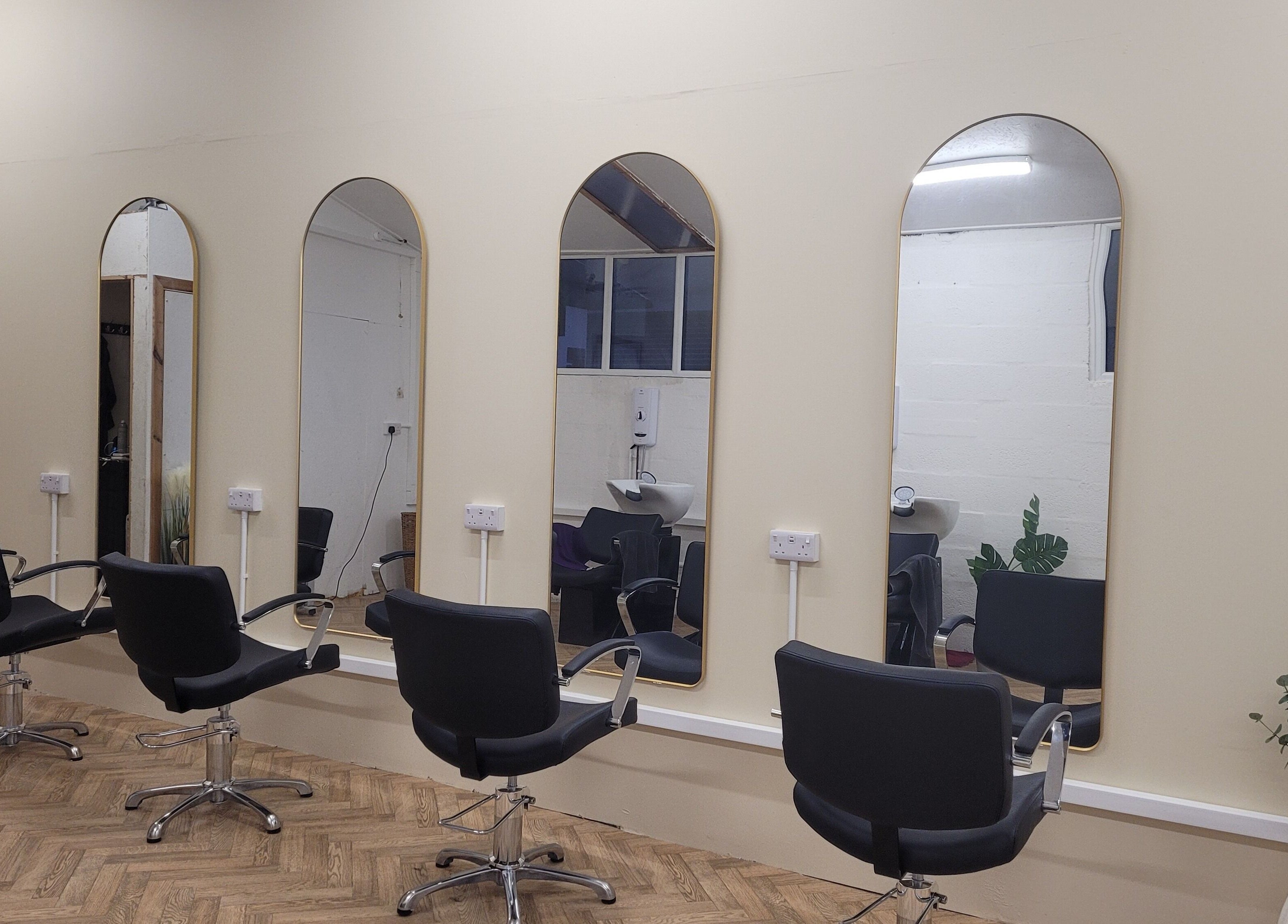 Stylish interior of Gareth at The Loft Hair Studio in Bristol, England, GB with chic mirrors and chairs.