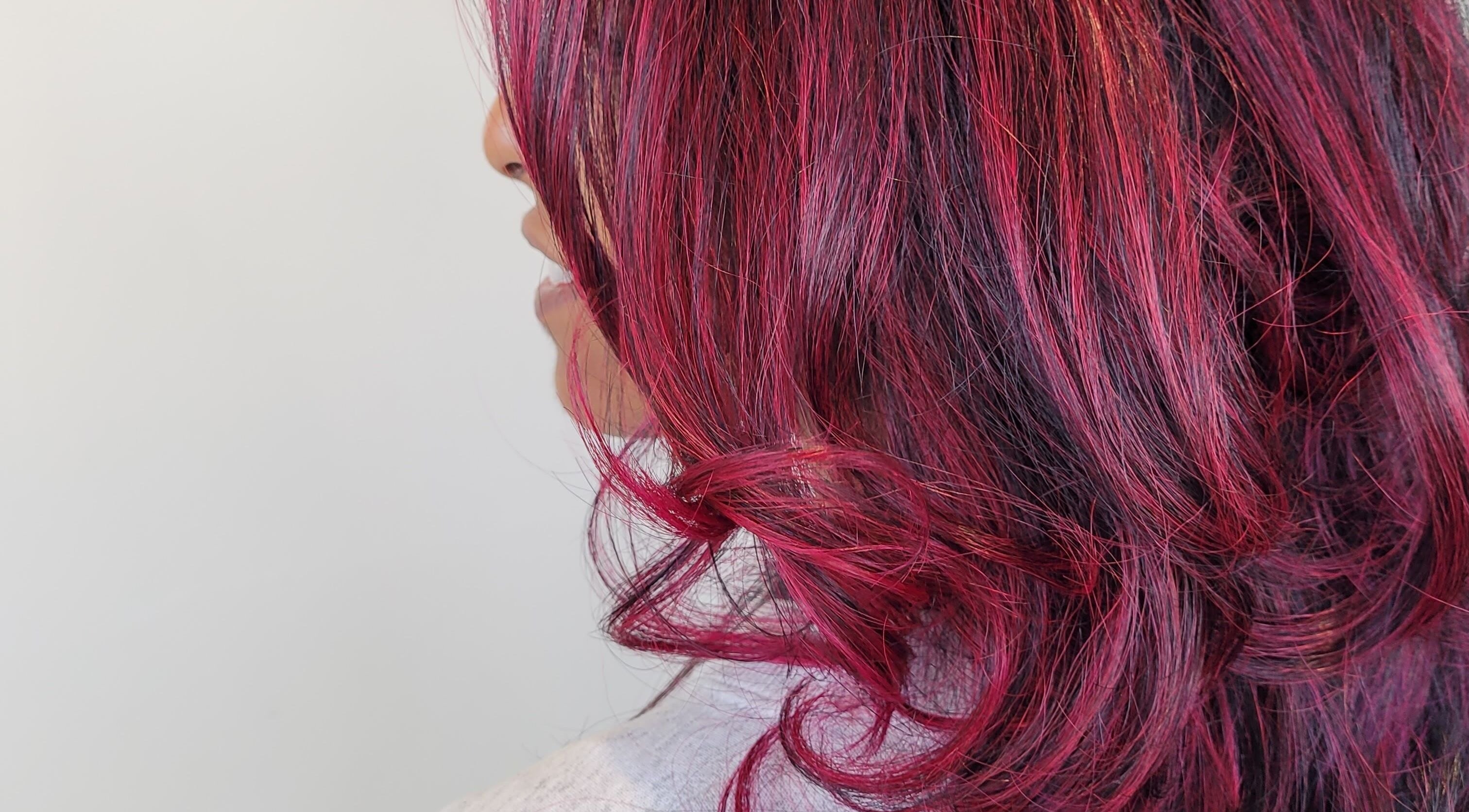 Crimson red curls styled at Gareth at The Loft Hair Studio, Bristol, England, GB.