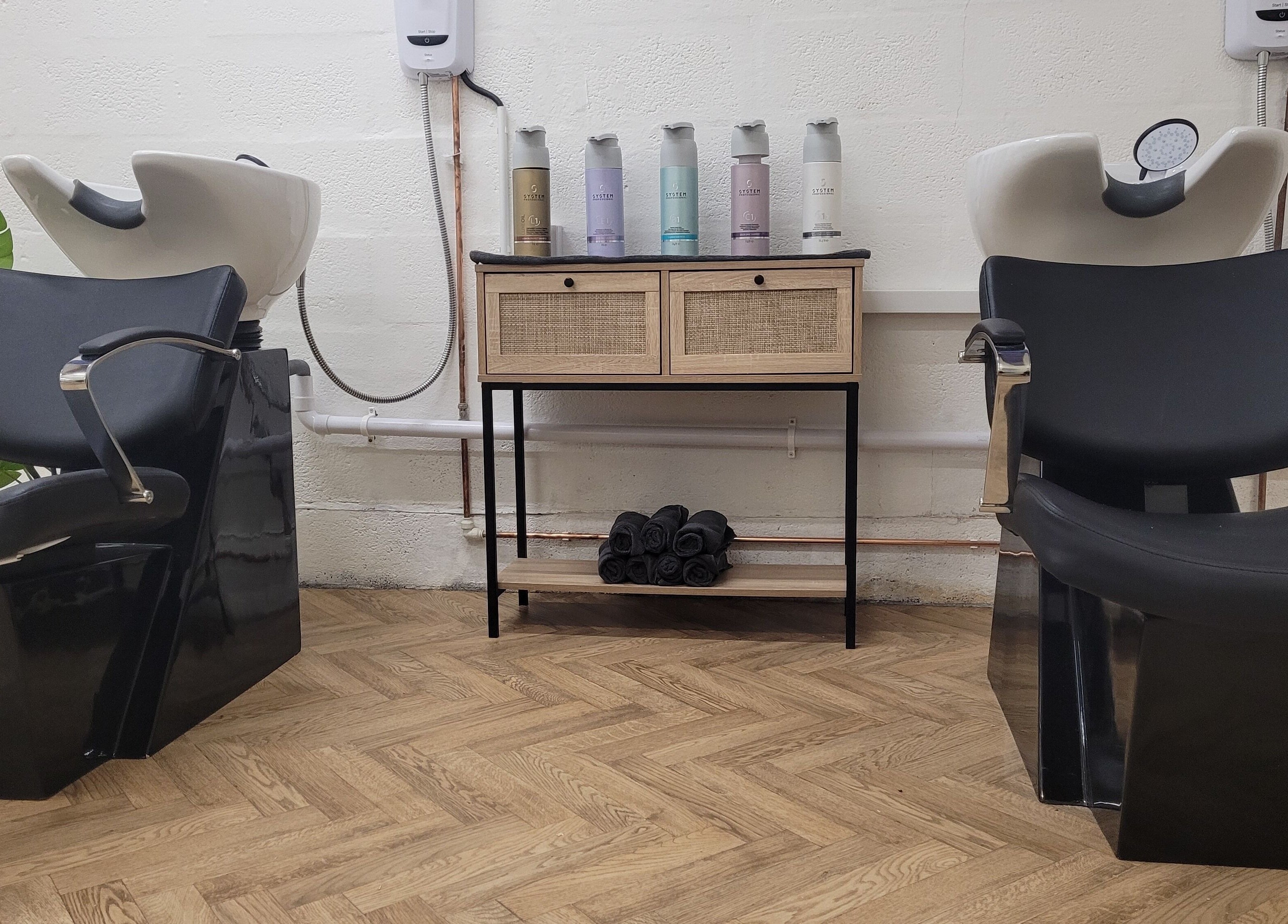 Modern wash station setup at Gareth at The Loft Hair Studio, Bristol, England, GB featuring sleek black chairs.