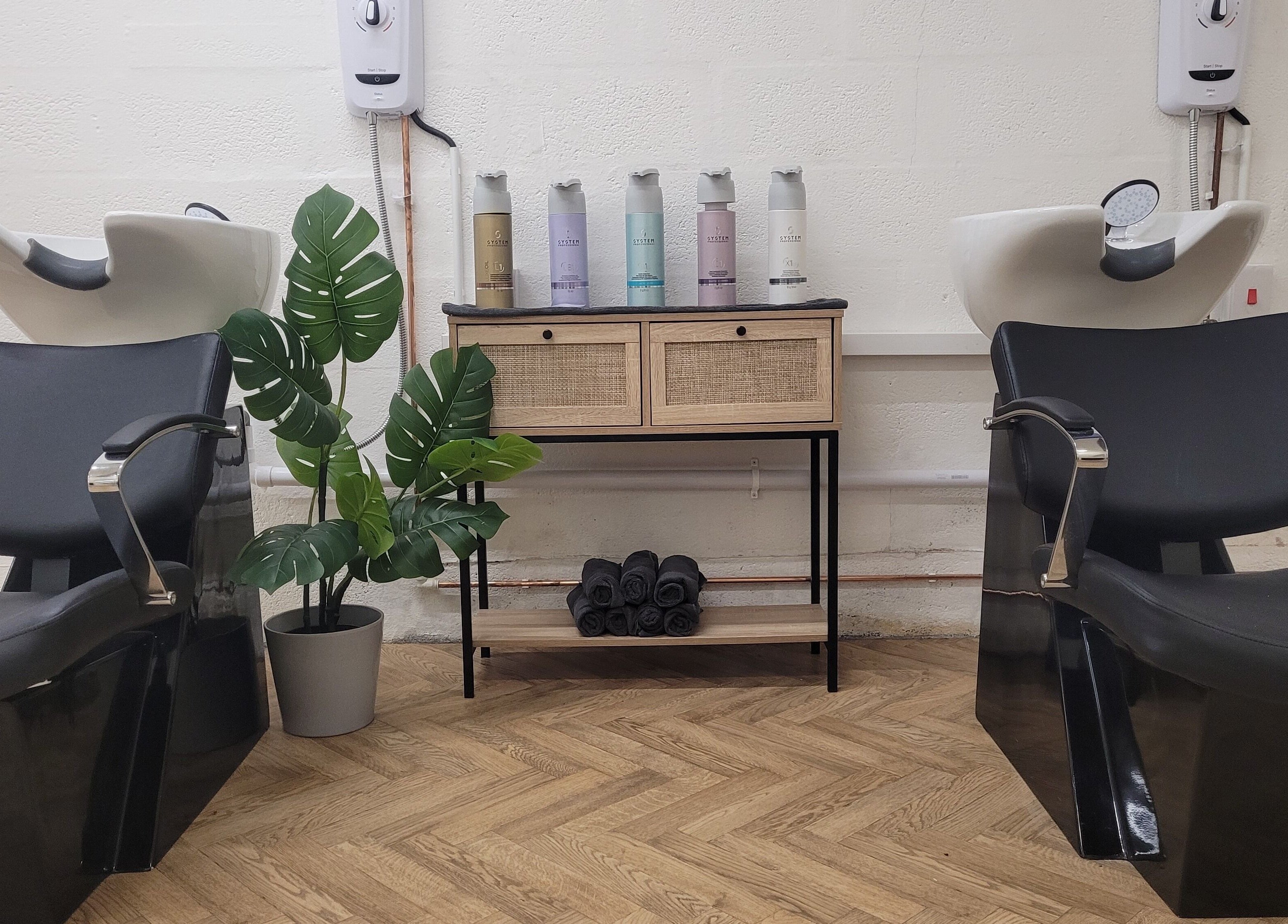 Chic wash station at Gareth at The Loft Hair Studio, Bristol, England, GB, with elegant chairs and decor.