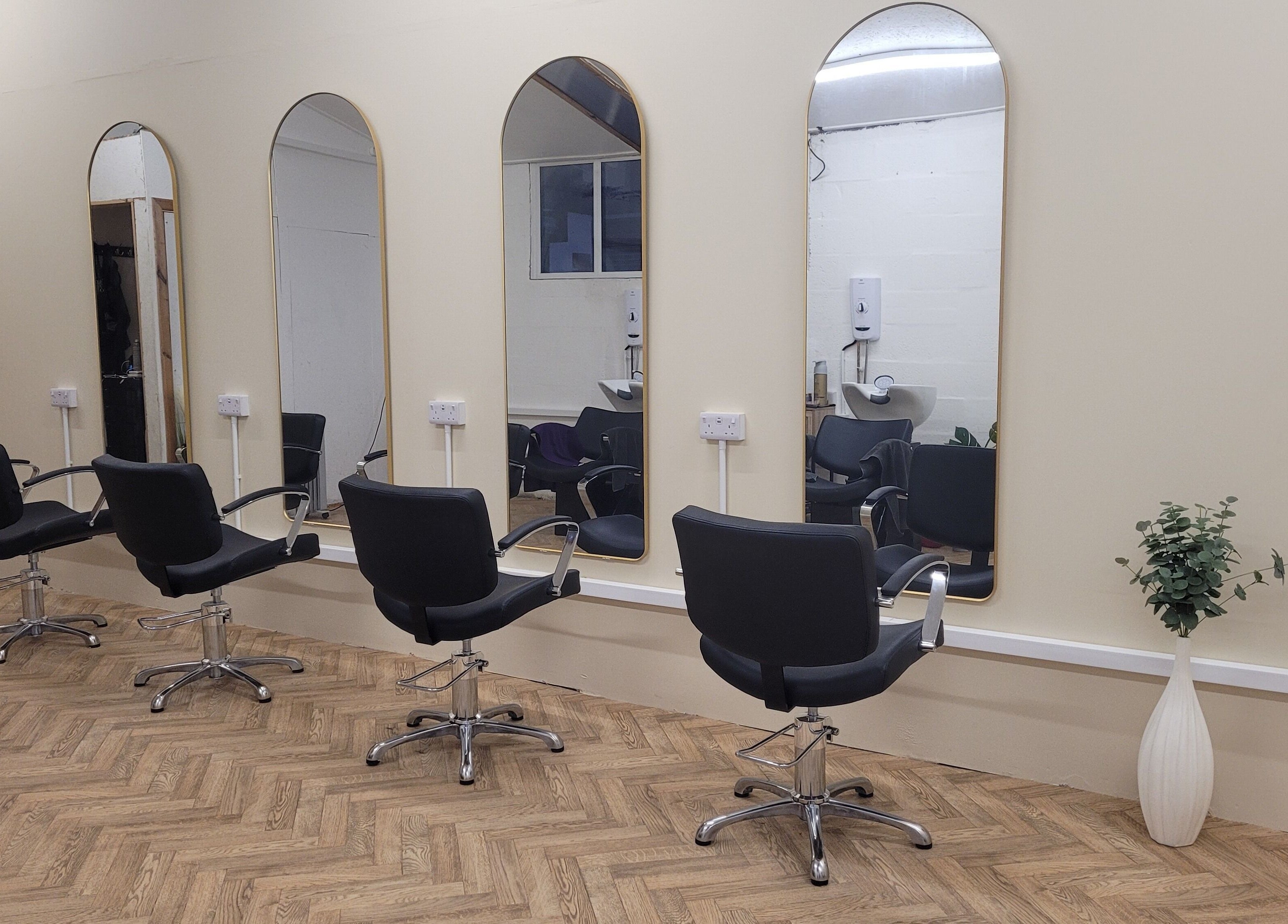 Modern salon interior with styling chairs and mirrors at Gareth at The Loft Hair Studio, Bristol, England, GB.