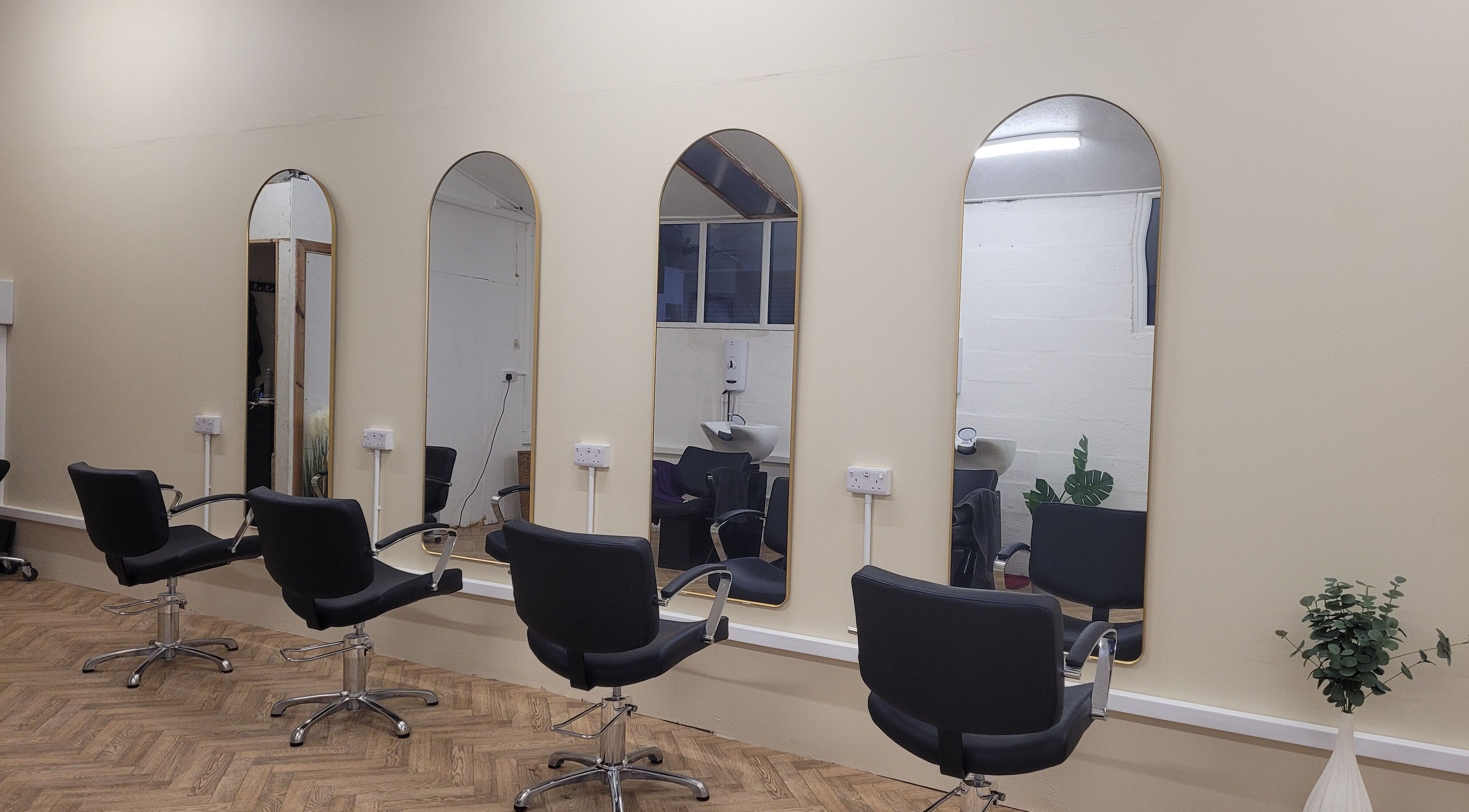 Chic interior of Gareth at The Loft Hair Studio in Bristol, England, showcasing stylish mirrors and salon chairs.
