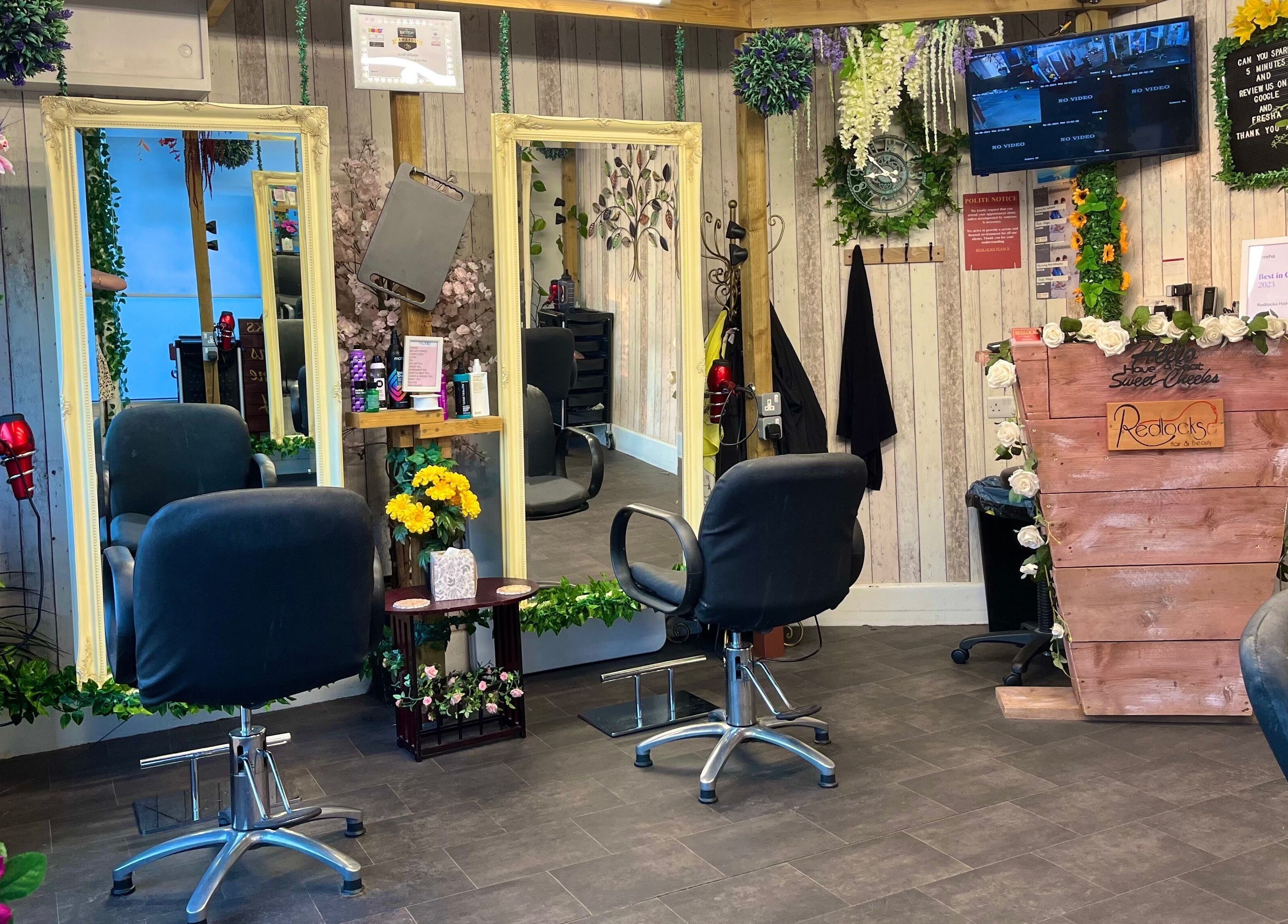 Elegant salon chairs and rustic decor at Redlocks Hair, Bournemouth, England, GB, creating a welcoming ambiance.