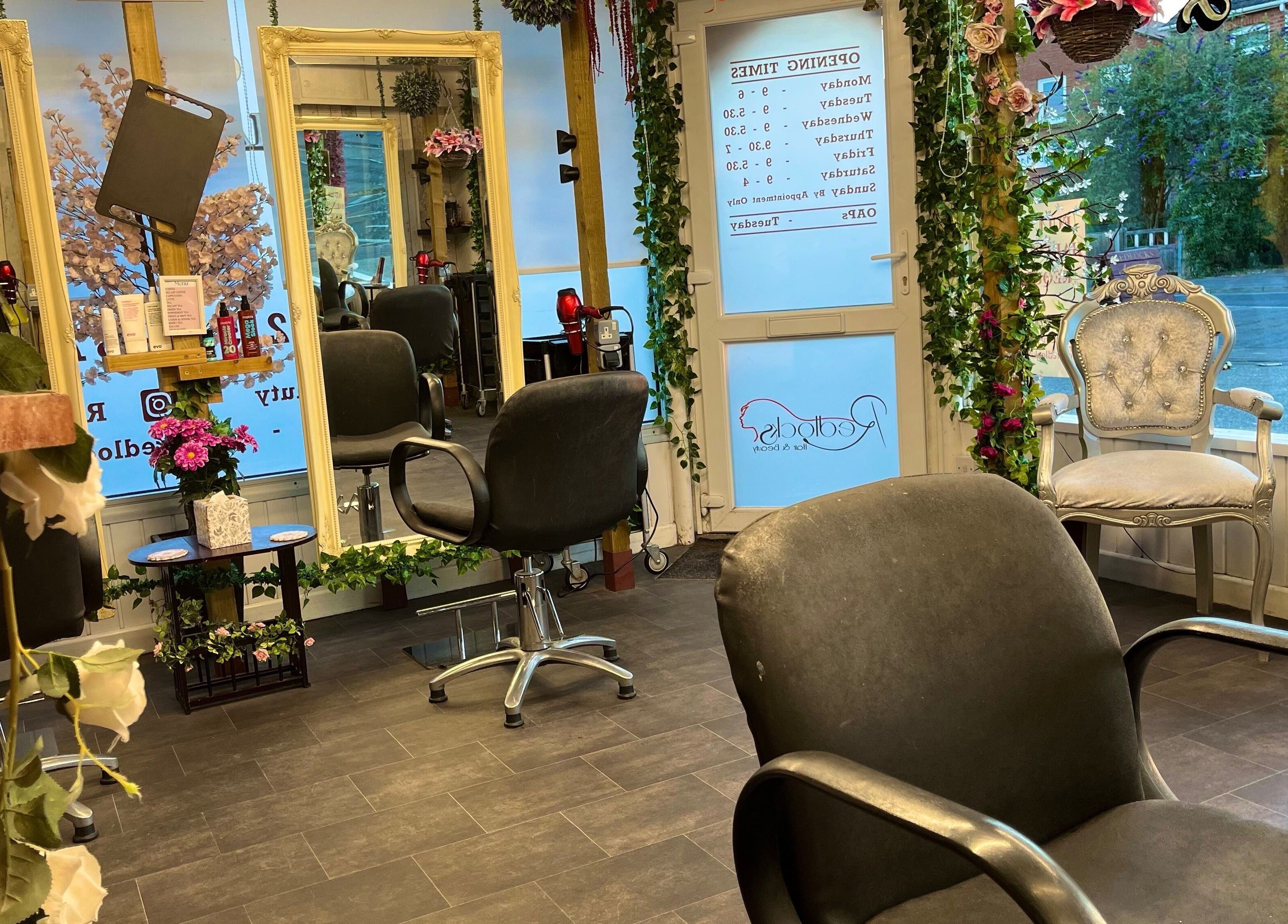 Chic interior of Redlocks Hair in Bournemouth, England, GB featuring modern chairs and elegant decor.