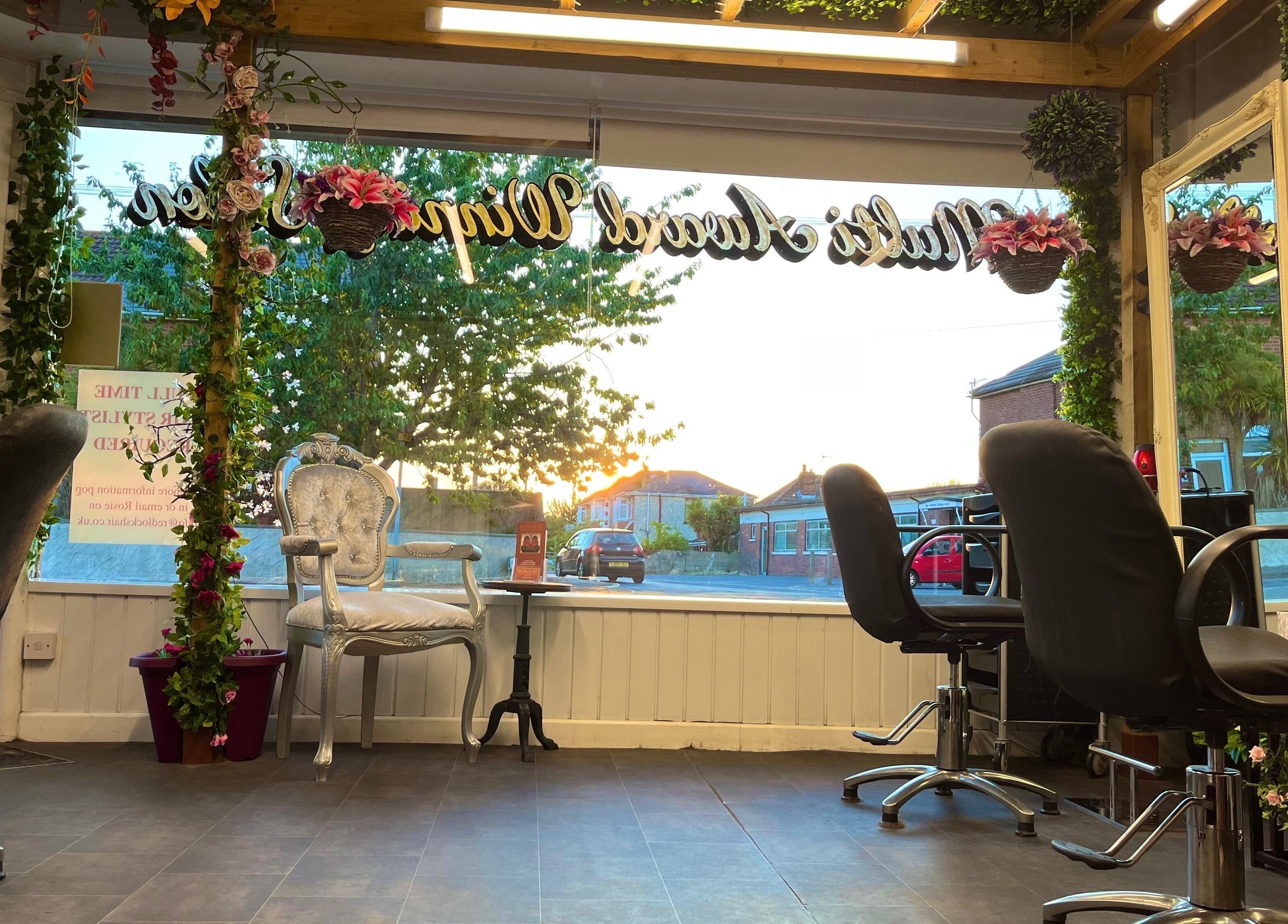 Charming interior of Redlocks Hair with elegant chairs and decor in Bournemouth, England, GB.