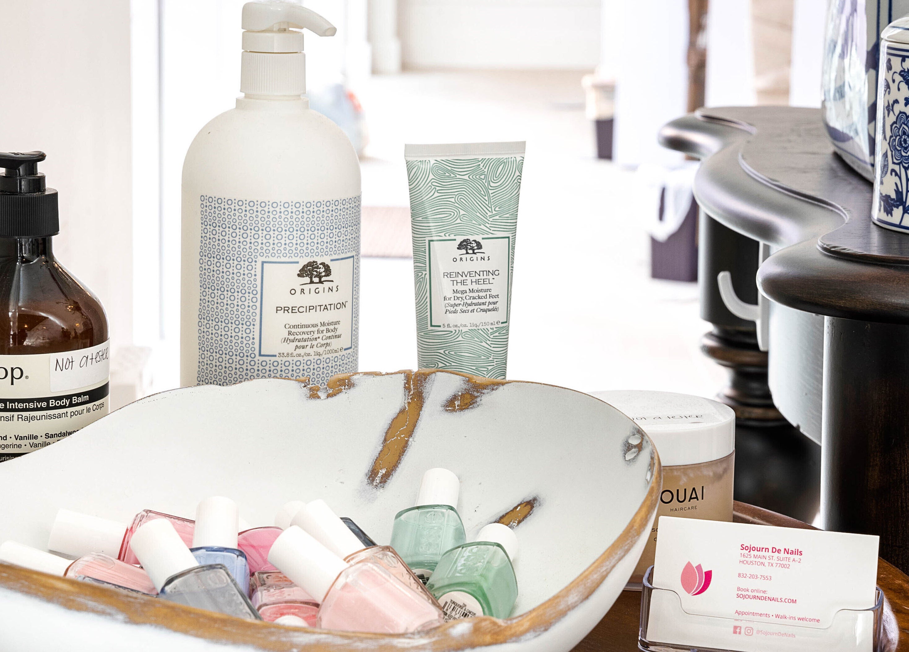 Sojourn De Nails beauty products display in Houston, Texas, US featuring nail polish and skin lotions.