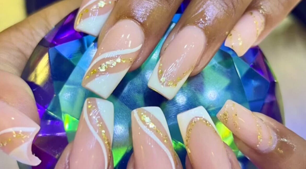 Elegant nail art at Lifestyle on Location - Midrand, Midrand, Gauteng, ZA, showcasing gold accents and a gem.