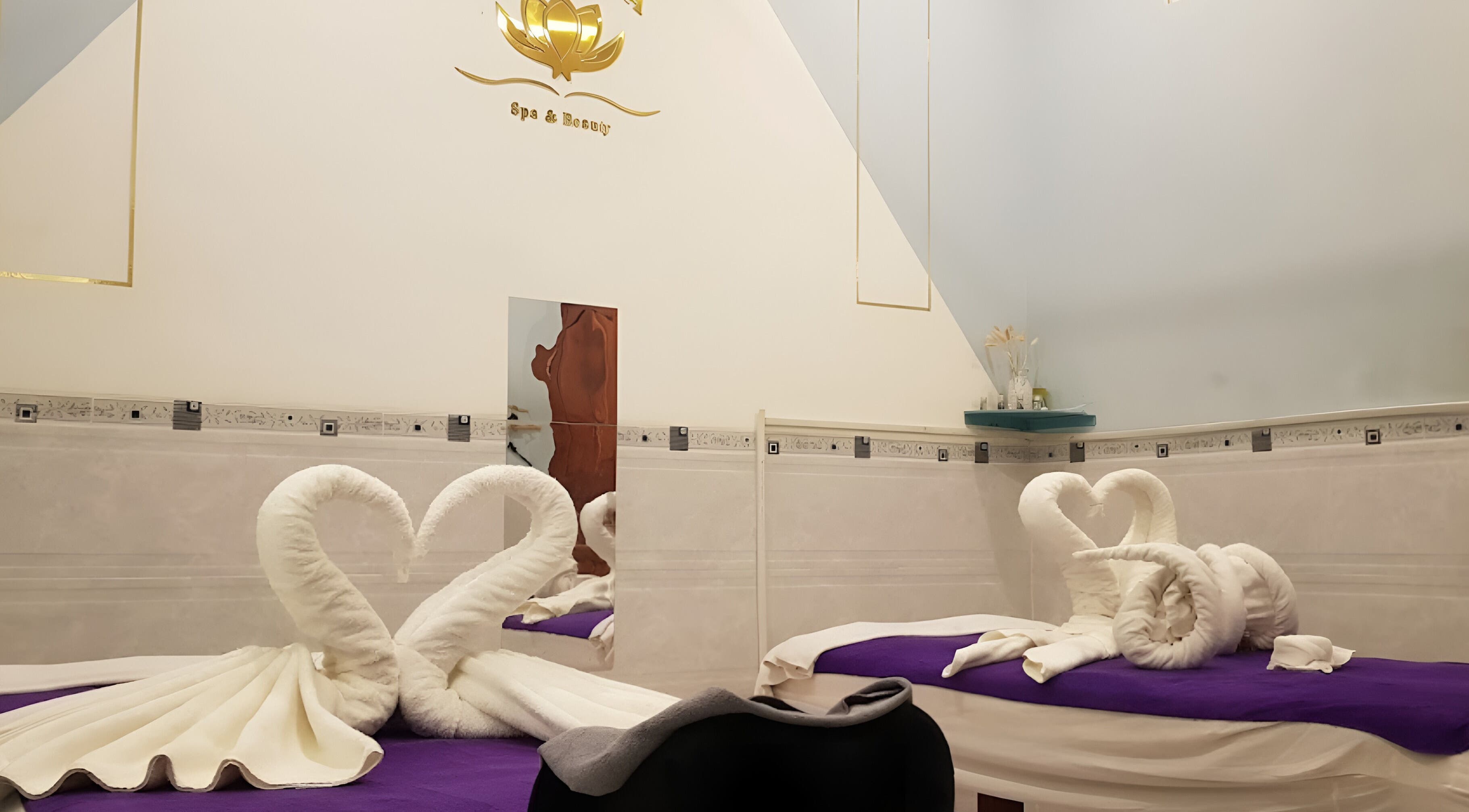 Elegant massage room at Lotus Spa 1, Thành phố Phú Quốc, Kiên Giang, VN with towel swans on beds.