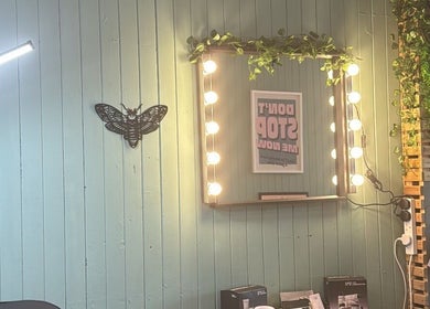 Vanity mirror with bulbs and plant decor at Peak Physique and Bodywork Kirkcaldy, Kirkcaldy, Scotland, GB.