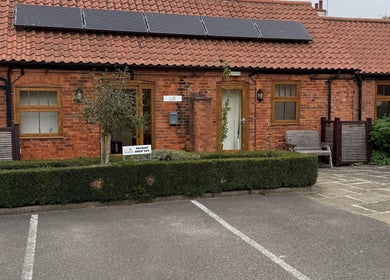 Charming brick facade of Beauty by Tracy Polak in Eakring, England, GB welcoming guests.